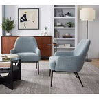 Sillón tapizado, estructura de metal negro, azul claro