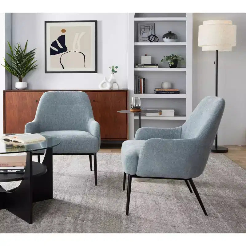 Sillón tapizado, estructura de metal negro, azul claro
